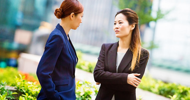 signs-someone-tolerates-you-but-doesnt-actually-like-you Two asian woman talking about something