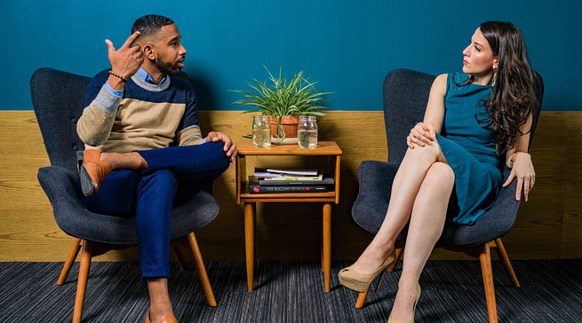untitled-design-40 A man & a woman having a chat sitting in a office
