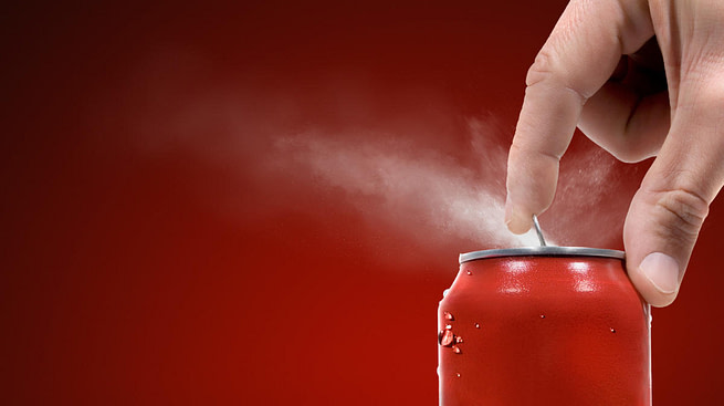 46b8cc8406e76a99d4340817d79de297 A hand opening a soda can