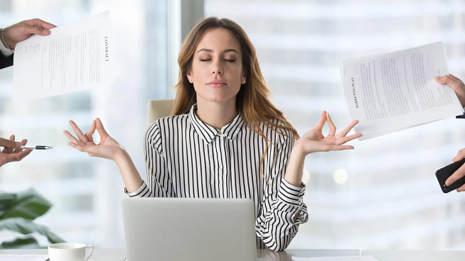 A woman in office looks very relaxed