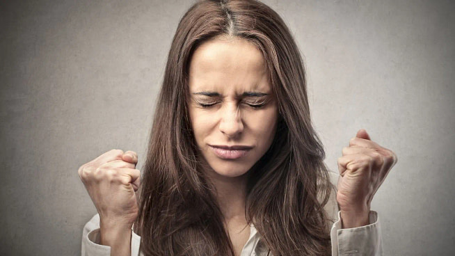 122.-self-directed-anger A woman feeling very angry and seems in control at the same time