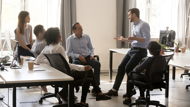 1721502178220 Office employees having a conversation