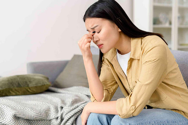 unnamed a lonely tensed woman sitting in a sofa looks very upset